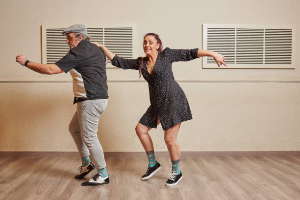 istock Dance couple doing a lindy hop dance move 1393276623