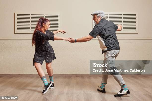 Dance Couple Doing A Lindy Hop Dance Move Stock Photo - Download Image Now - Dancing, Learning, Lindy Hop