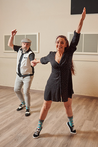 Mature couple dancing lindy hop to improve coordination, balance, improve blood pressure and prevent joint pain