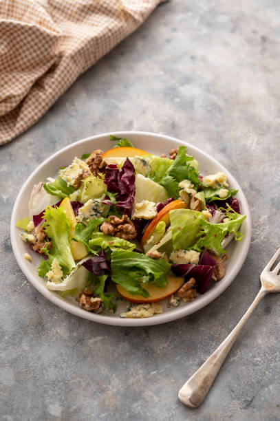 istock Salad with blue cheese, apples, arugula and nuts with spicy dressing on a grey background. Healthy eating. 1393277123