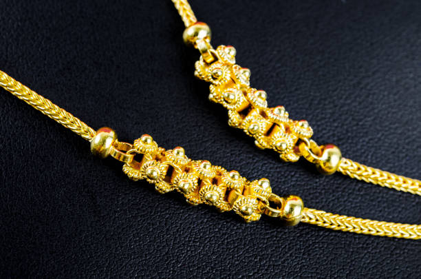 istock Close up Gold necklace on black leather. 1393277885