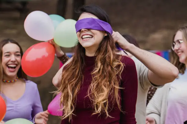 group of friends playing with blindfold on eyes and laughing