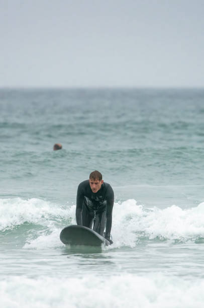 istock Young man surfing off the Cornish Coast 1393279469