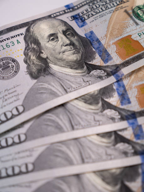 istock 100 US dollars bills lie on the table close-up 1393280625