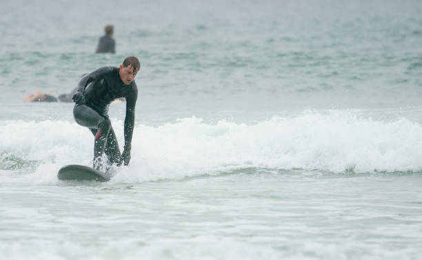 istock Young man surfing off the Cornish Coast 1393281822