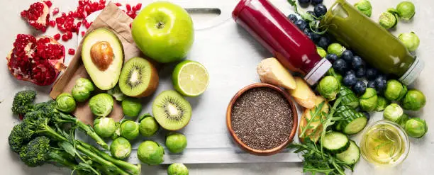 Photo of Assorted detox smoothie juices on light background.