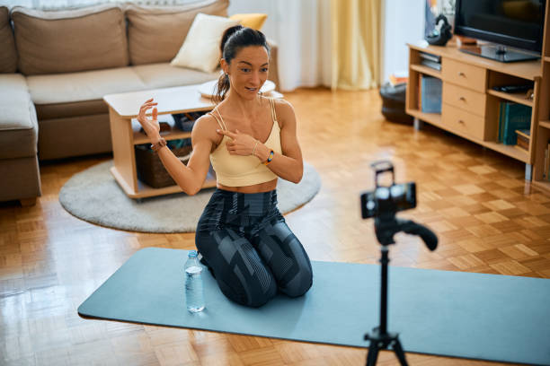 istock Athletic woman giving instructions while live streaming during home workout. 1393283232