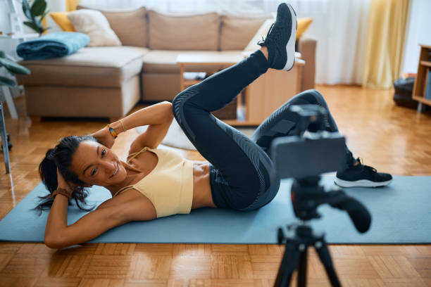 istock Happy fitness instructor live steaming while working out at home. 1393283890