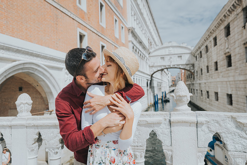 Beautiful romantic couple having fun in Venice city - Tourists traveling in Italy together in famous sightseeing - Holidays and happy lifestyle concept