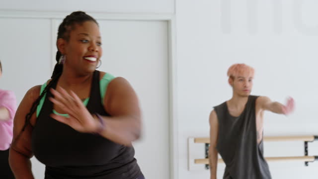 Diverse group of people practicing fitness dance in class