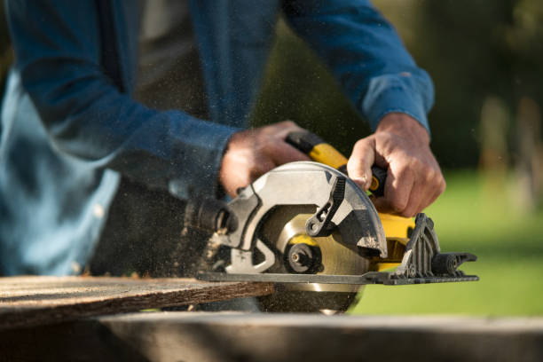 istock Close-up of craftsman working with circular saw at construction site 1393287219