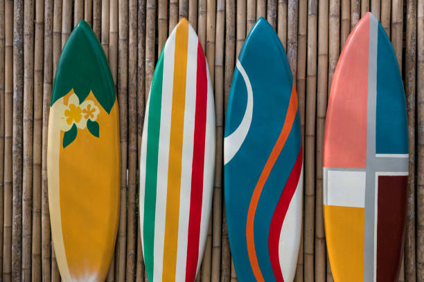 istock colorful paint surfboards on bamboo wooden wall 1393290076