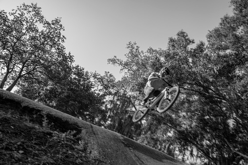 This is a photograph of a man with a beard and red hair on a mountain bike on a sunny outdoor morning in Orlando Florida