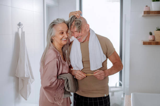 istock Senior couple in love in bathroom, having fun, morning routine concept. 1393296428