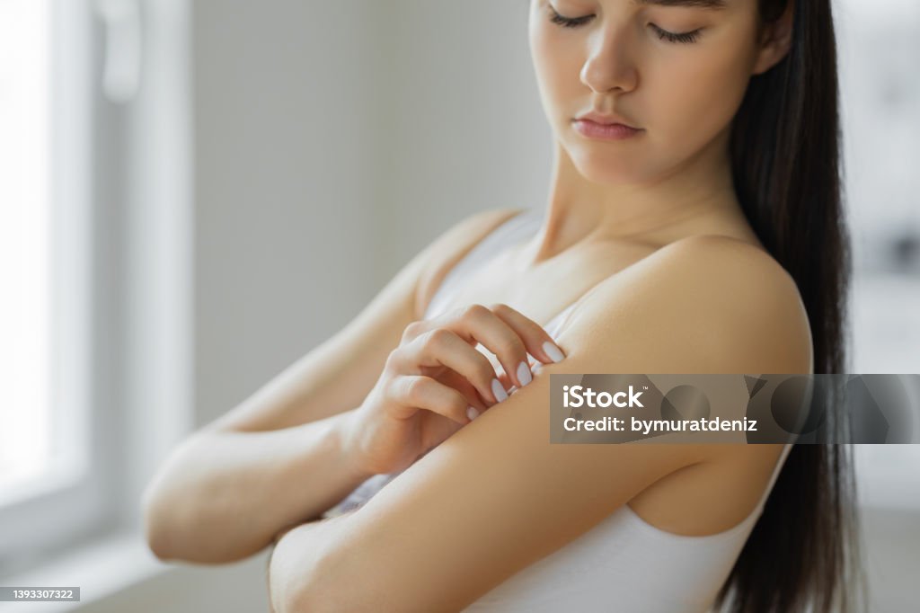 Young woman scratching her arm Mosquito Stock Photo