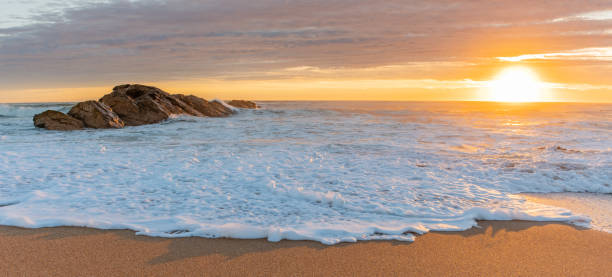 istock Glowing skies at dusk on a summer evening on an Atlantic ocean beach. 1393312059
