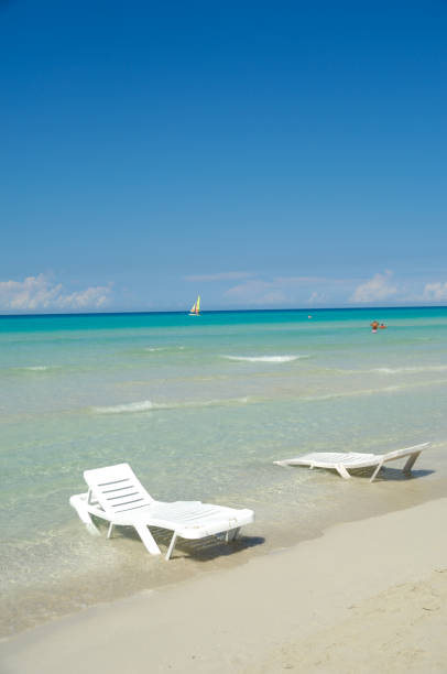 istock Sunloungers at exotic beach 1393313710