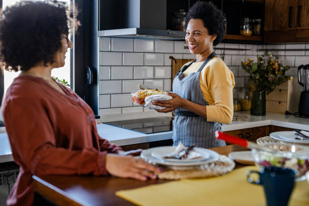 istock Lesbian couple having dinner at home 1393315378