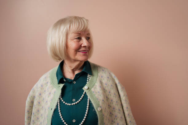 istock Smiling elegant elderly woman on pink color background, studio portrait 1393319229