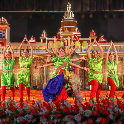 A Bharatanatyam art of dance depicting Goddess Durga performed in traditional Indian saris in an entertainment show for the tourists visiting Mysore, India.