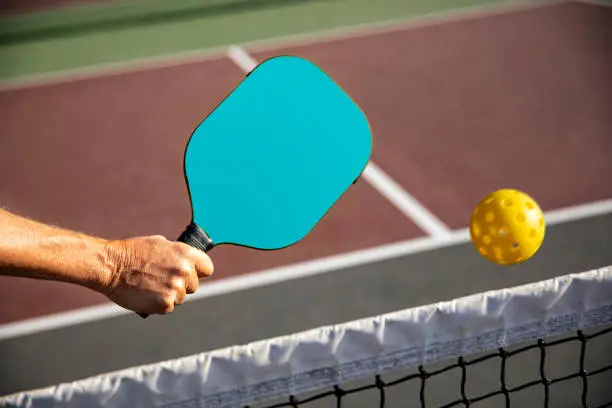 Photo of Pickleball Paddle Shot and Ball on court
