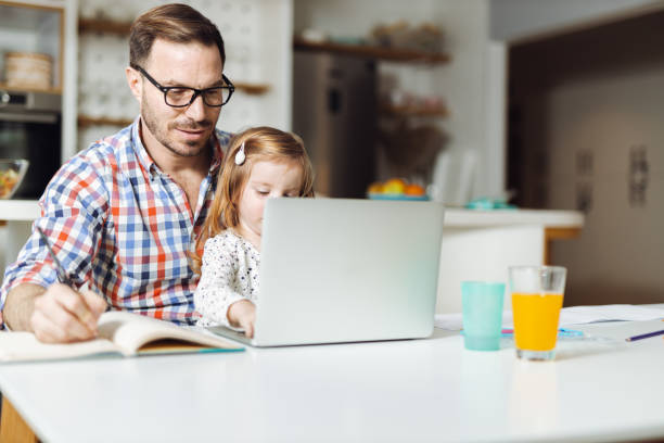 istock Young father and his small girl using computer at home 1393340445