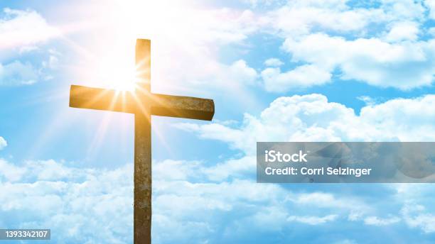 Religious Background Old Steel Cross With Blue Sky Clouds And Sunbeams Stock Photo - Download Image Now