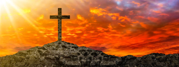 istock Easter or Religion background banner panorama religious greeting card - Old ruine stone wall and cross in the sunset, with orange glowing sky 1393342122