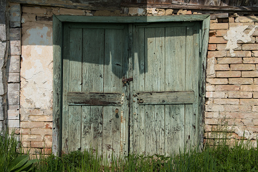 Croatia, April 20,2022: Old wooden rustic doors on rural home wall.