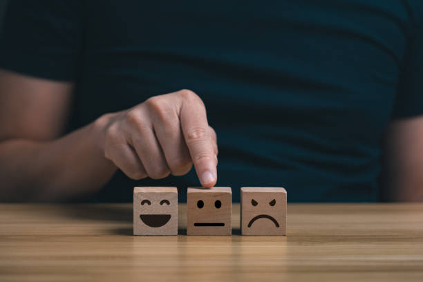 istock Customer's hand commented with a bad smiley card, service score, satisfaction concept. symbol feedback scale emoticon happy till sad and bad service 1393348142