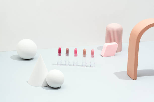 Cosmetics flat lay, packaging mockup, template with geometric objects on white and gray background. Colorful lipsticks with sphere, cone and geometric shape objects.