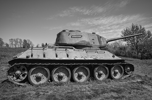 Kyiv, Ukraine - August 14, 2017: The old russian tank near the statue of mother motherland is famous its huge dimansions. Steel statue has lengh 62 m (203 ft) tall upon the museum building with the overall structure measuring 102 m (335 ft) and weighing 560 tons. It was opened in 1981. In bottom part is located Museum of the Great Patriotic War. This place is very popular among tourists.