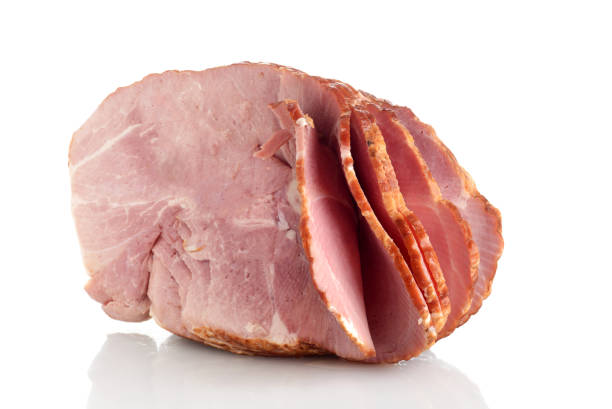 Applewood Smoked Spiral Sliced Bone In Half Ham Applewood Smoked Spiral Sliced Bone In Half Ham on a white background uncooked bacon stock pictures, royalty-free photos & images