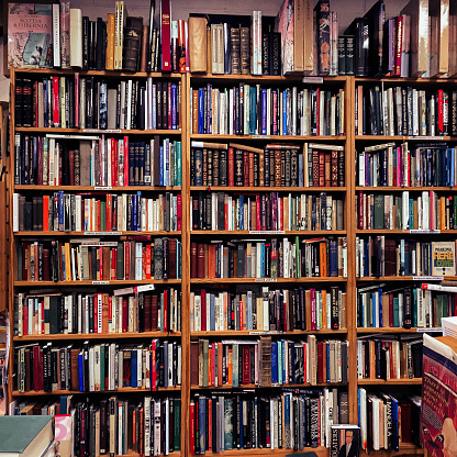 A full bookshelf in a store of second hand books.