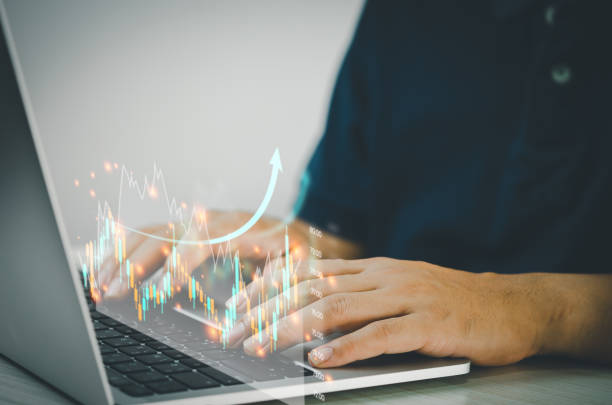 istock Man hands using computers to analyze data and investment charts. Financial trading plans and digital banking technology marketing. 1393356291