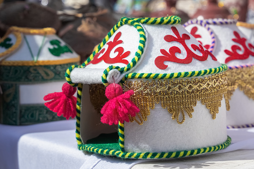 Souvenir model of a felt house of nomads - yurts, decorated with metal ornaments, ribbons and thread tassels. Handmade