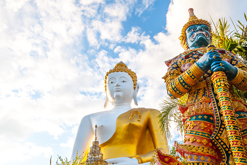 Giant statue and Big Buddha statue Wat Phra That Doi Kham at Chiang Mai,Thai temple Northern Thailand.