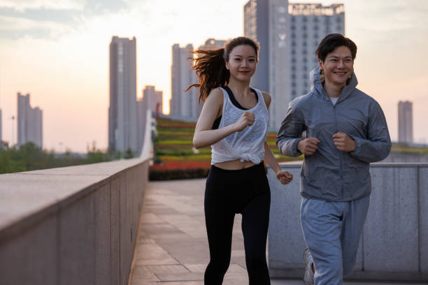 istock Couple jogging and running outdoors in city 1393360444