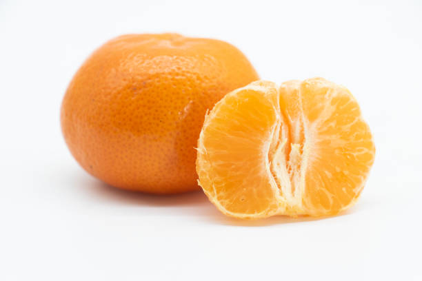 istock whole and slice Tangerine or komola isolated on white background, side view 1393360614