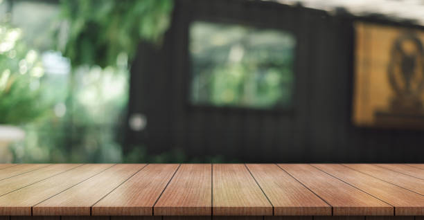 istock Empty wooden table top with lights bokeh on blur restaurant background. 1393363596