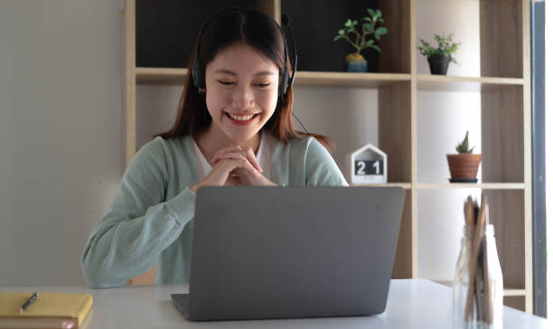 istock Smart Asian students find satisfaction while studying online on the Internet and meeting with friends to search for information on their laptops at home. 1393363757