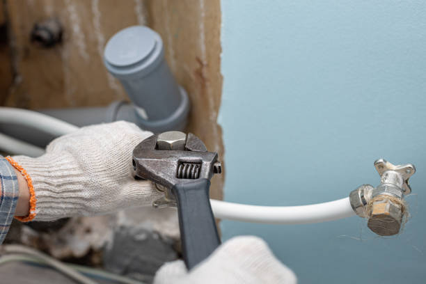 istock man unscrews the plug on the water supply pipe 1393366799