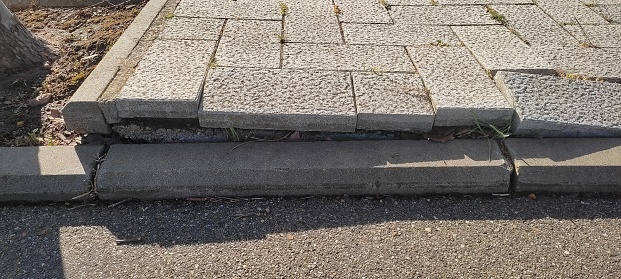Old defective cobblestone pavement due to incorrectly prepared base. High quality photo