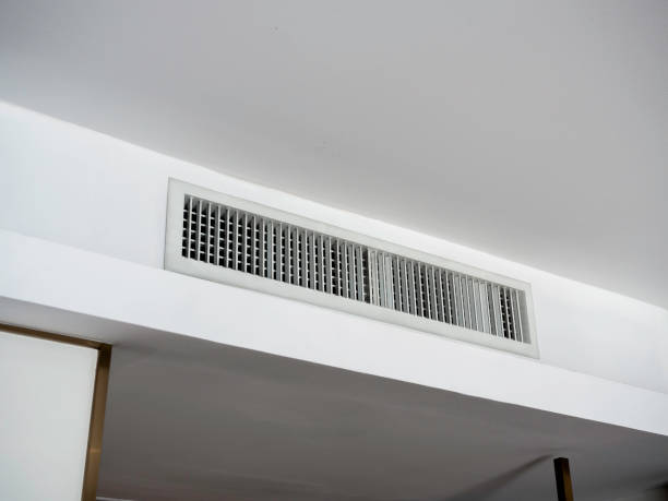 istock Air conditioning wall mounted ventilation system on ceiling in the white hotel room. Hotel room air ventilation grill on the wall. 1393367241