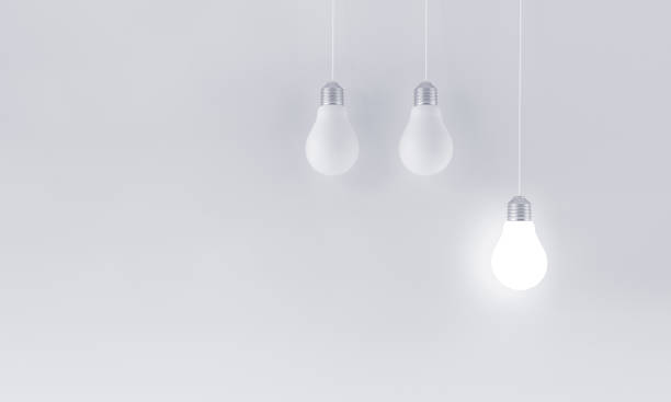 istock Hanging illuminated light bulb on minimalist white background. Innovation concept. 1393372317