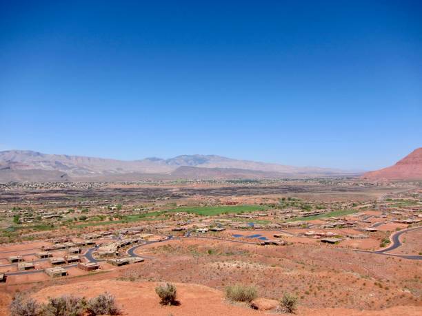 Ivins City in the Mojave Desert This beautiful view of Ivins is from the Turtle Wall and Paradise Rim Loop Trail in Red Cliffs Desert Reserve. Ivins City, a desert community in Utah, is a part of the St. George Metropolitan Area as a suburb and became a city in January 1998. The Tuacahn Center for the Arts, a non-profit arts organization, in Ivins City is located at the mouth of Padre Canyon, adjacent to Snow Canyon State Park. The breathtaking 2,000 seat outdoor Amphitheatre is surrounded by 1,500-foot red rock cliffs. Within the Kayenta Desert Community in Ivins, there is the Kayenta Art Village, a unique collection of art galleries, a small theatre and a cafe/restaurant. snow canyon state park stock pictures, royalty-free photos & images