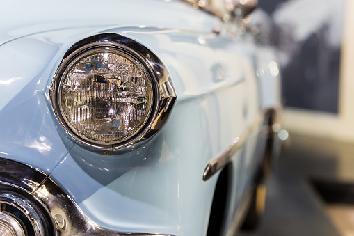 Classic Blue Antique Car Headlight with copy space and blurred background