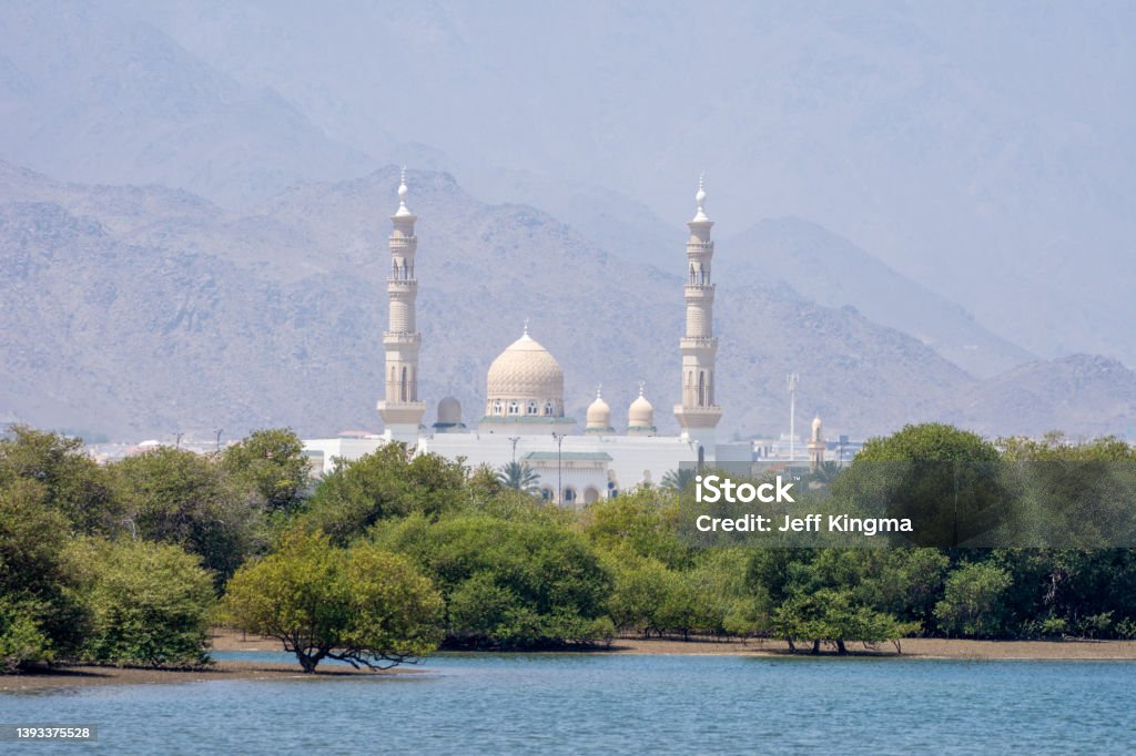 View across mangroves to Kalba Mosque in Sharjah, United Arab Emirates. Arab Culture Stock Photo