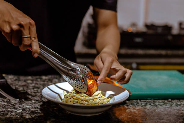 istock Chef preparing food salmon fillet pasta plate in the kitchen 1393377438
