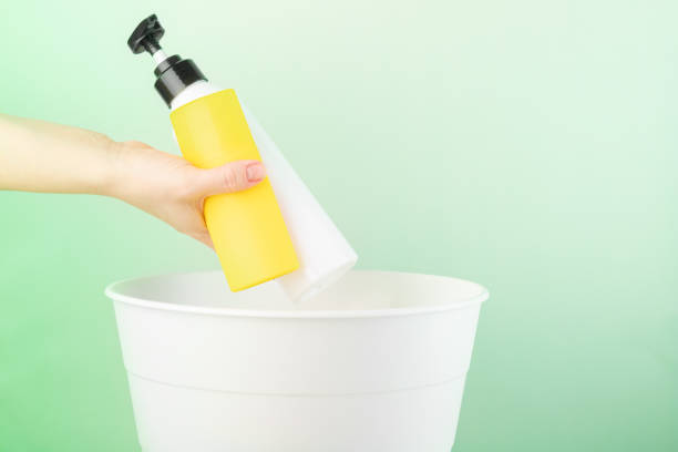 istock separate waste collection, plastic recycling, the hand throws the packaging of cosmetics into the trash 1393379173